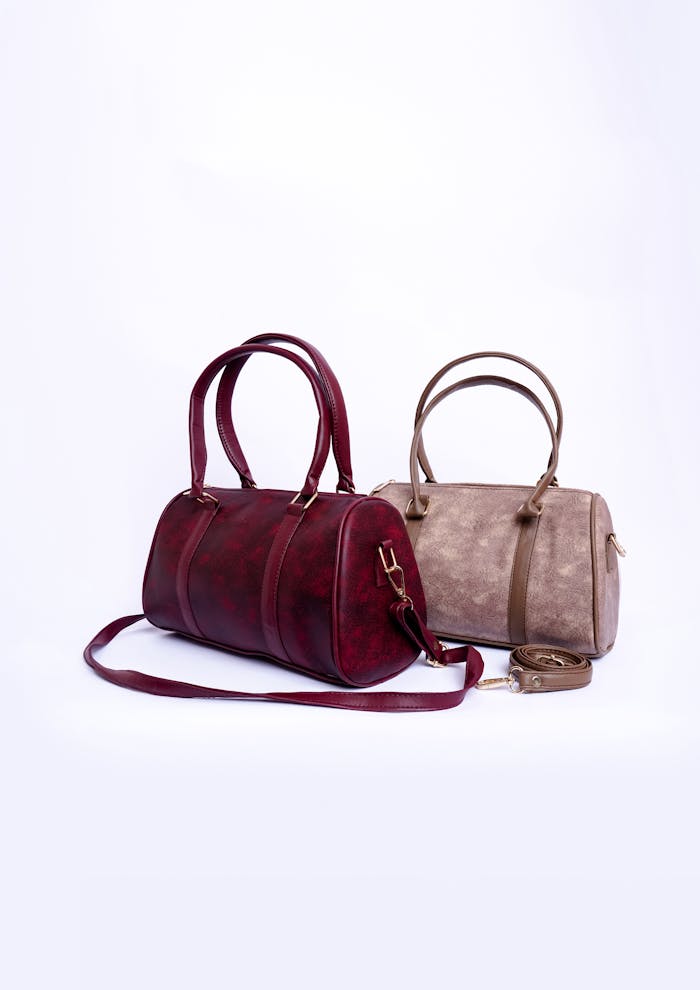 A stylish display of two elegant leather handbags against a white backdrop, perfect for fashion enthusiasts.